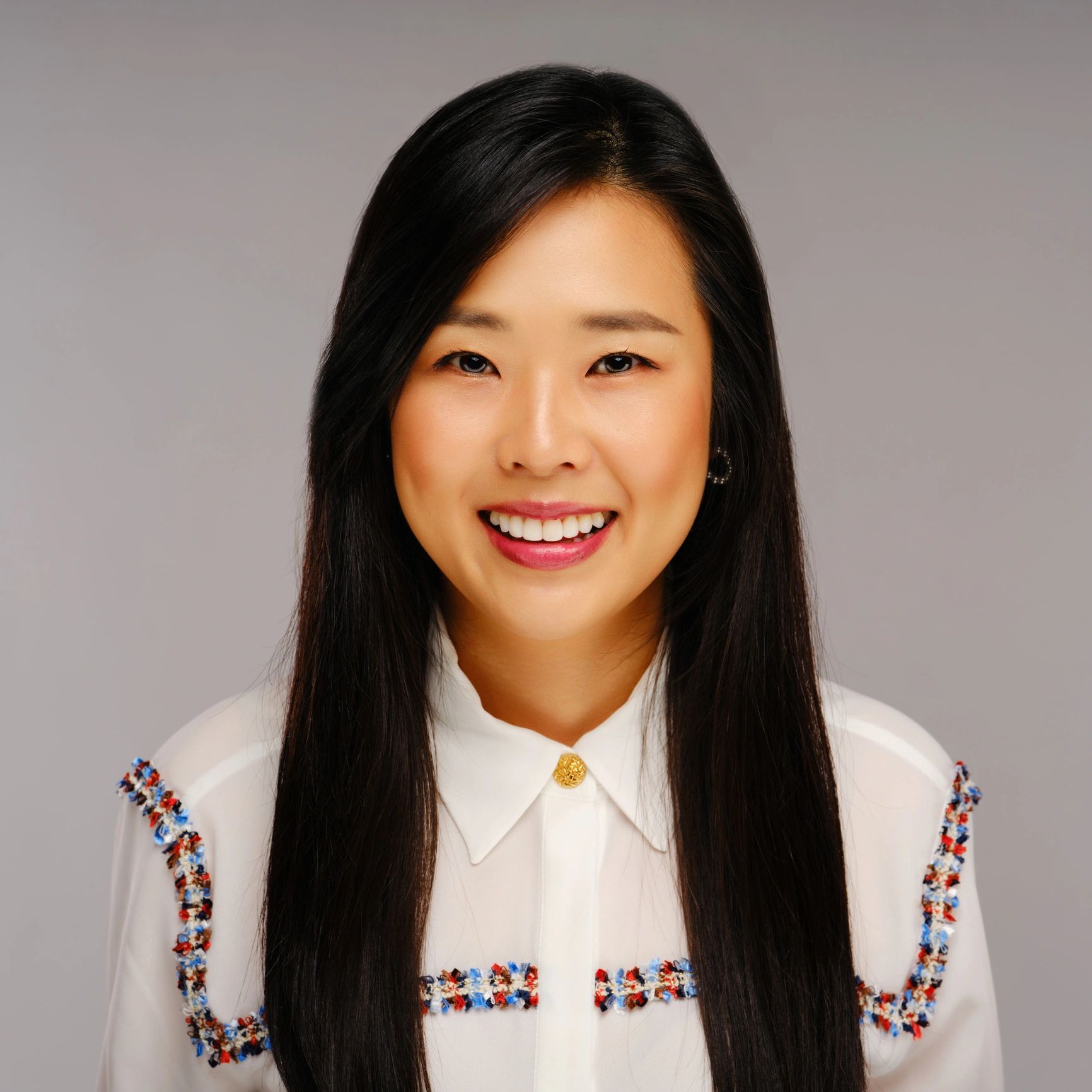 Professional headshot of a woman on a neutral background