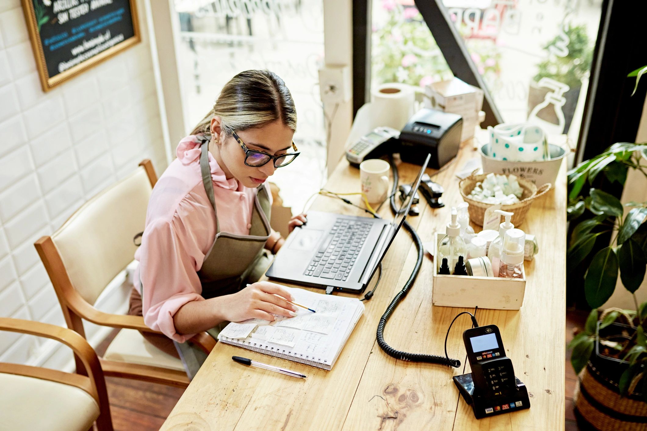 Small business owner working on laptop and bookkeeping