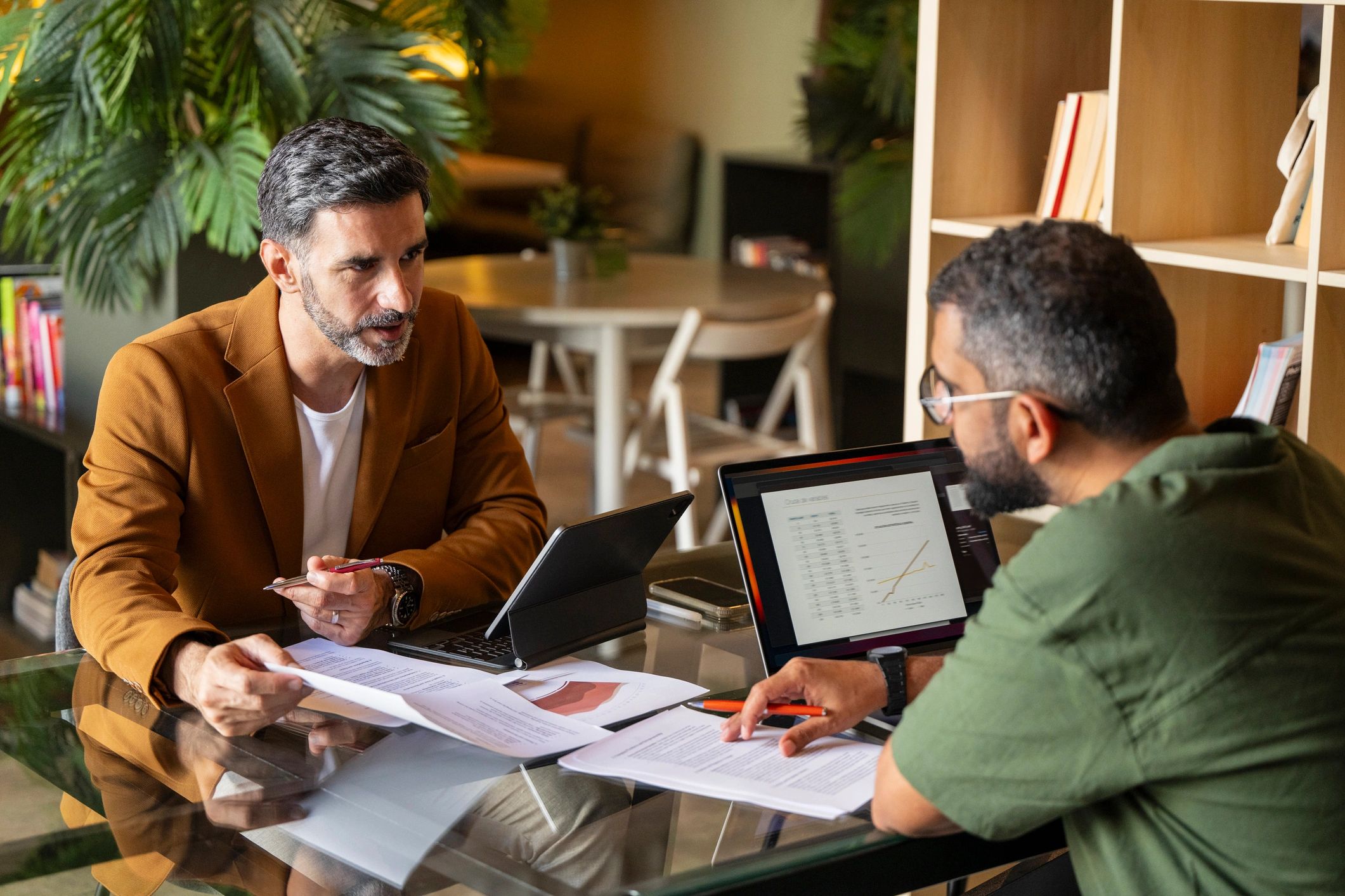 Professional consultation meeting with documents and laptops