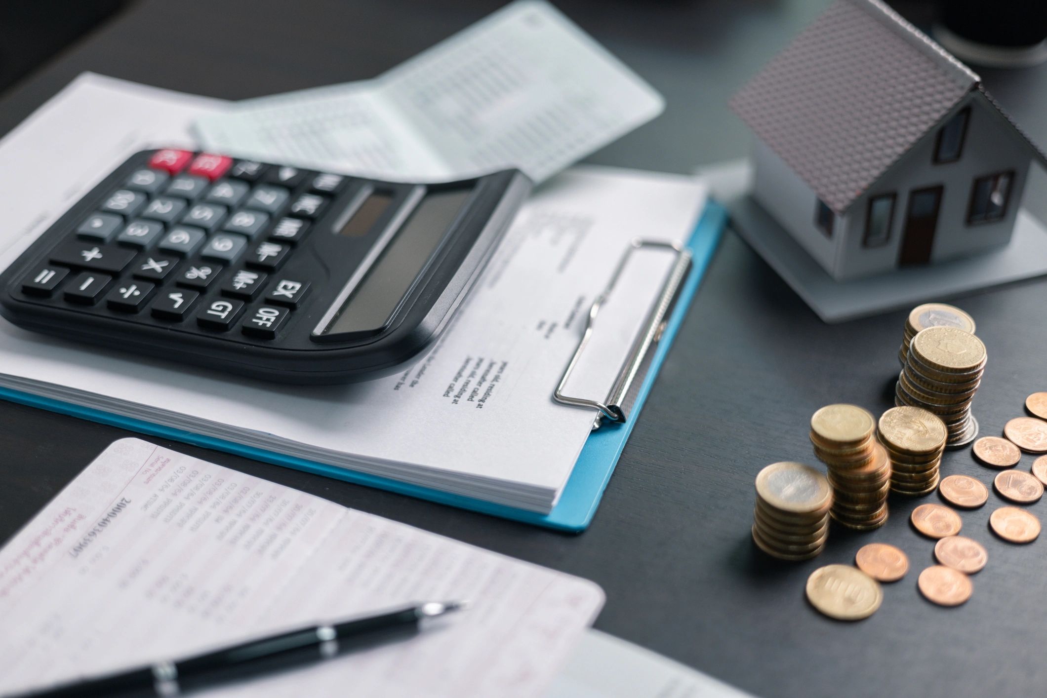 Hands using calculator with financial documents