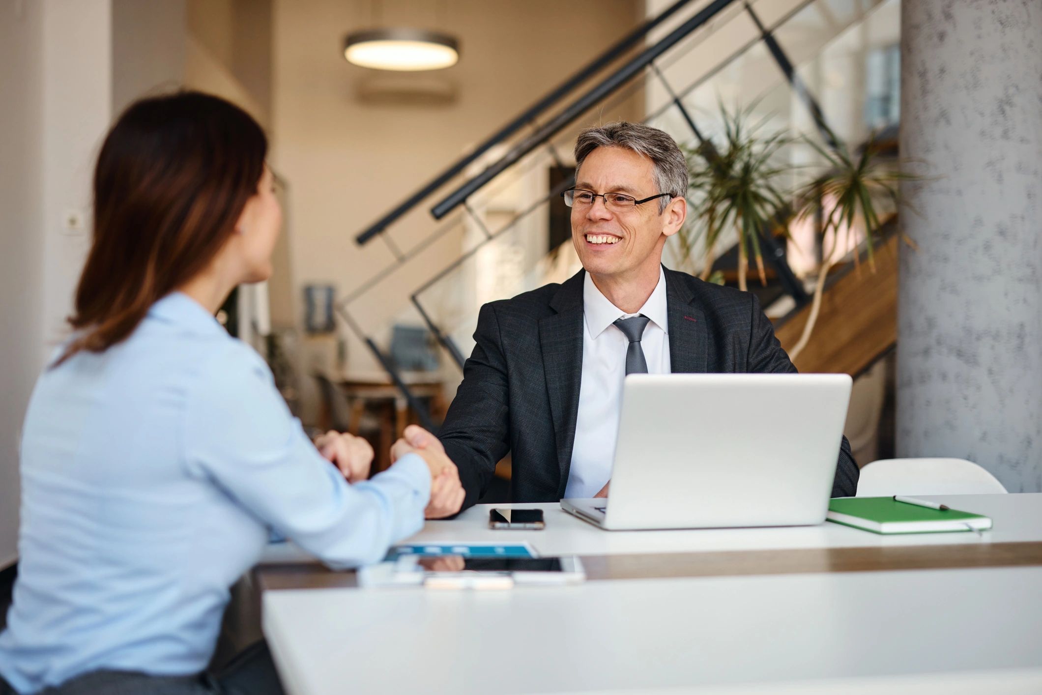 Tax professional meeting with a client at a desk