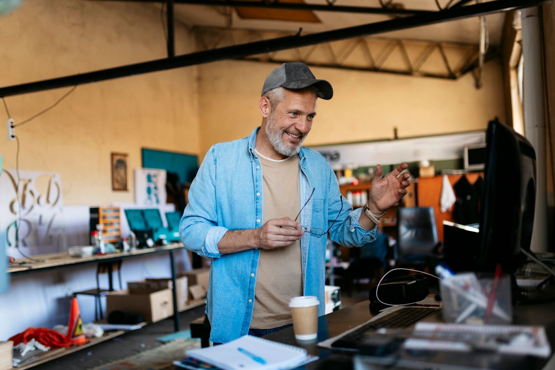 Small business owner in an automotive workshop reviewing paperwork