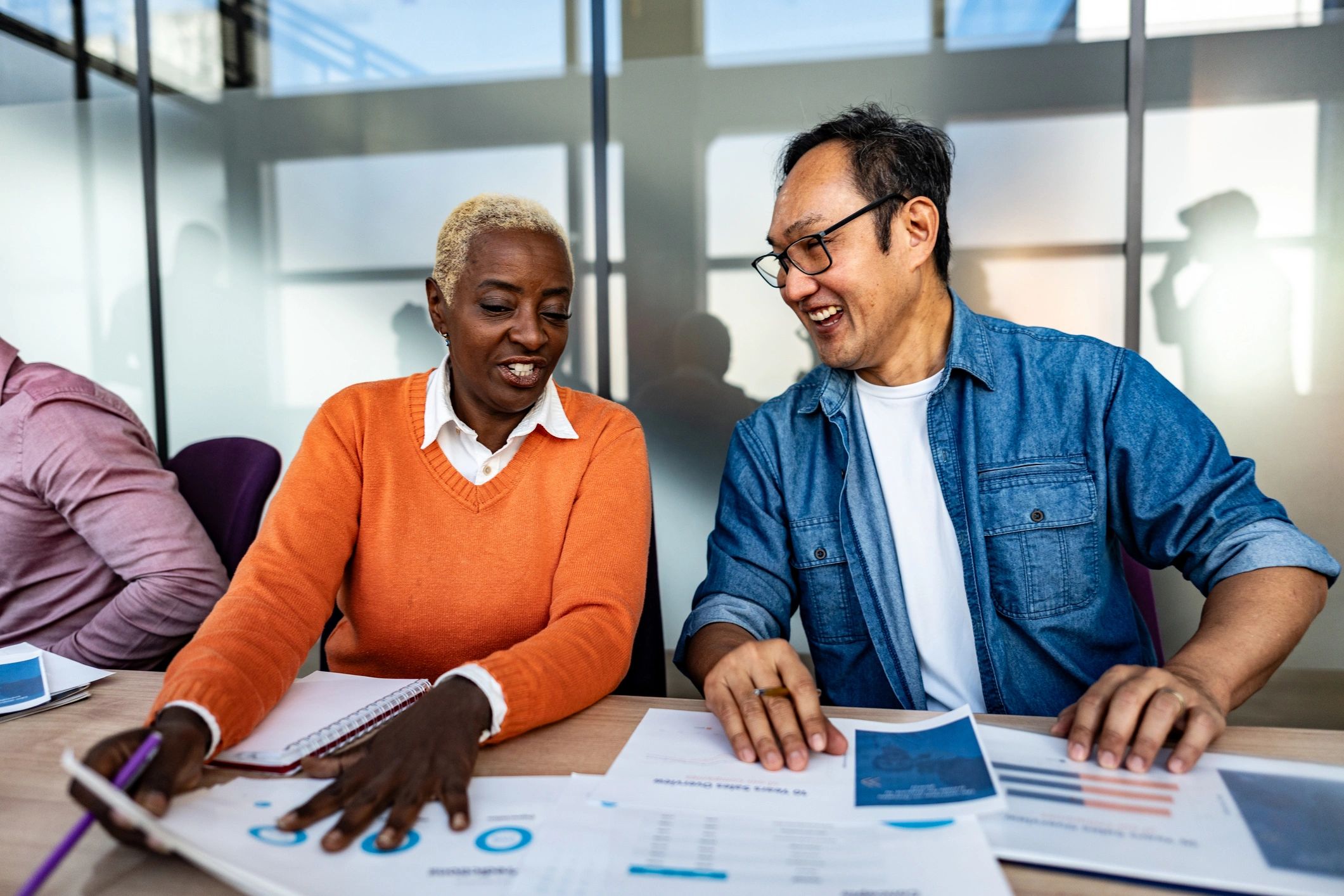 Two people reviewing financial documents together