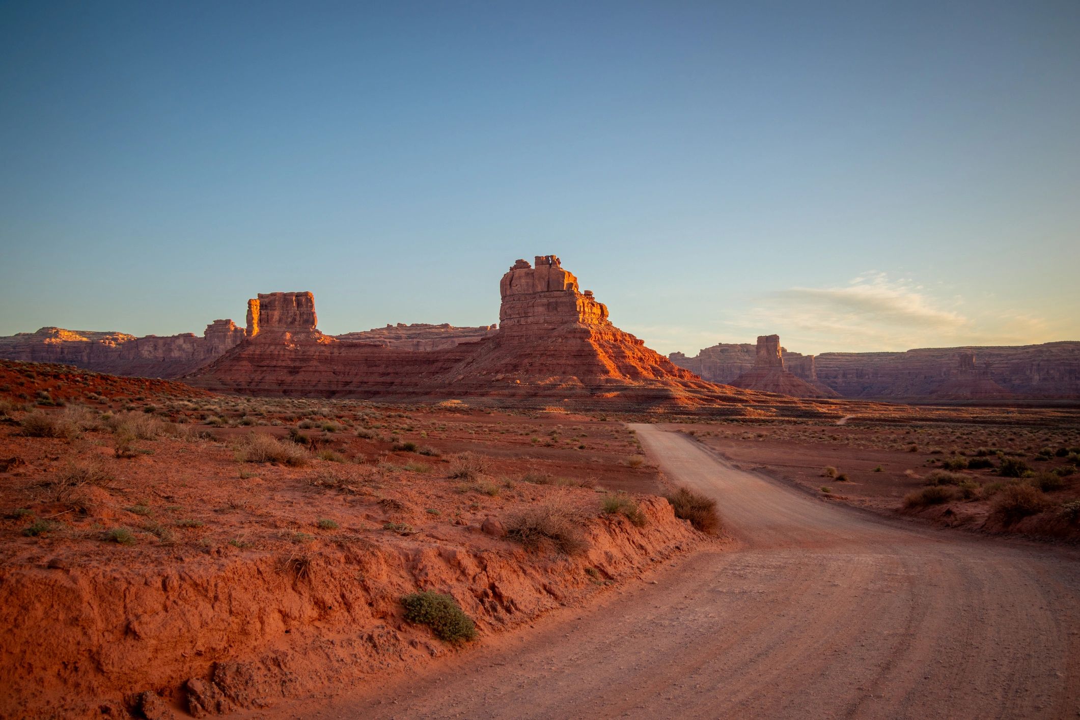 Desert dirt road at sunset, representing off-road adventure.